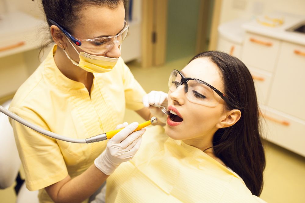 Dental hygienist performing professional teeth cleaning.